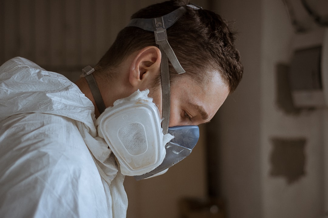 Cleanup worker wearing respiratory protective equipment